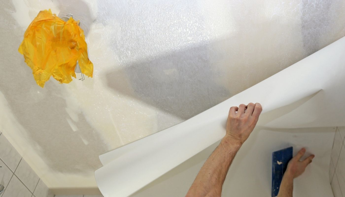 شخص يقوم بتنظيف ورق الحائط والبانوهات بعناية للحفاظ على جودتها ولمعانها